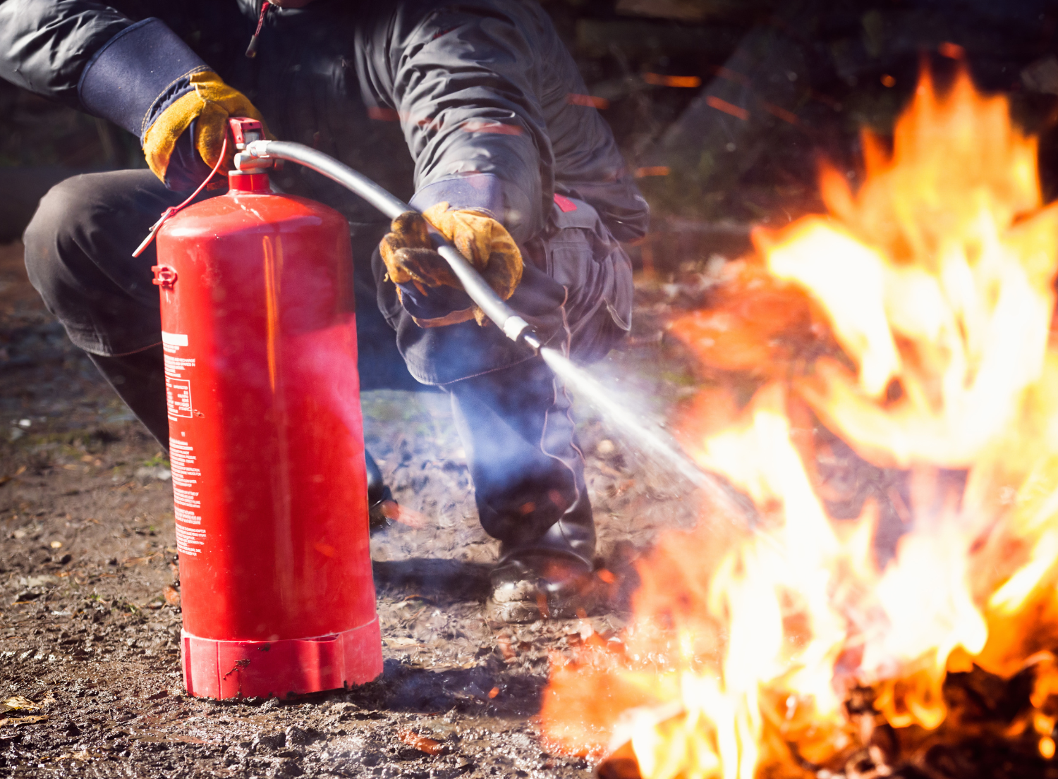 fireman putting out blazing fire with fire extinguisher