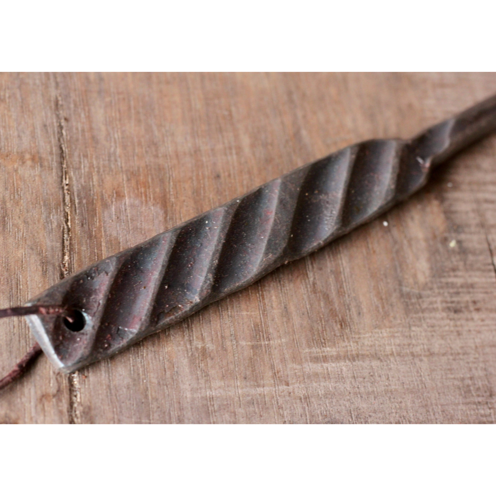 Metal drill bit on a wooden surface