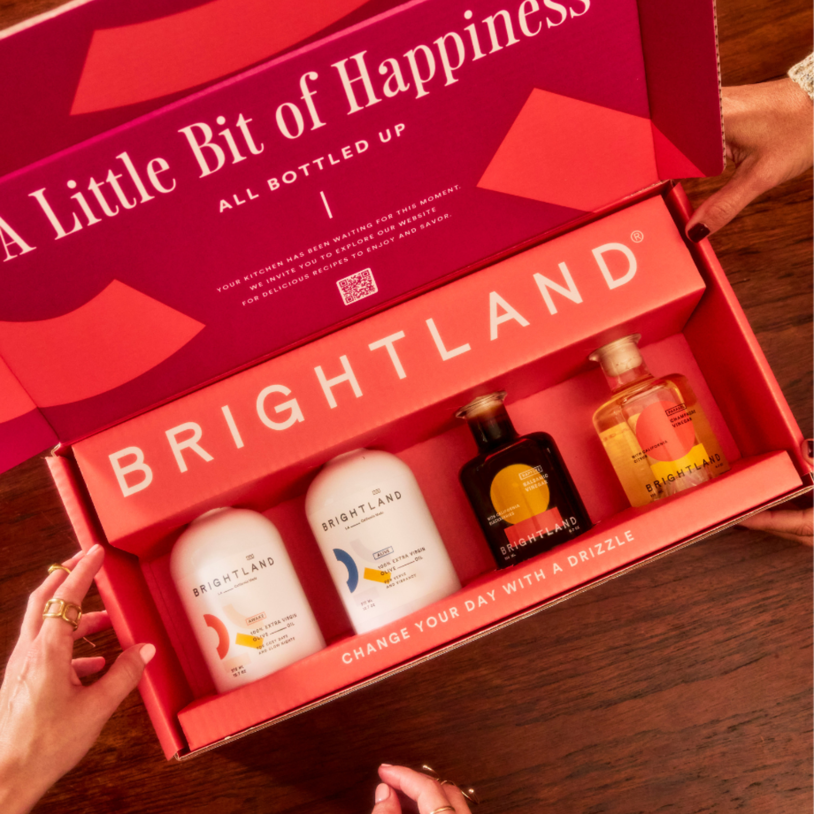 Open Brightland gift set with products inside on a wooden surface