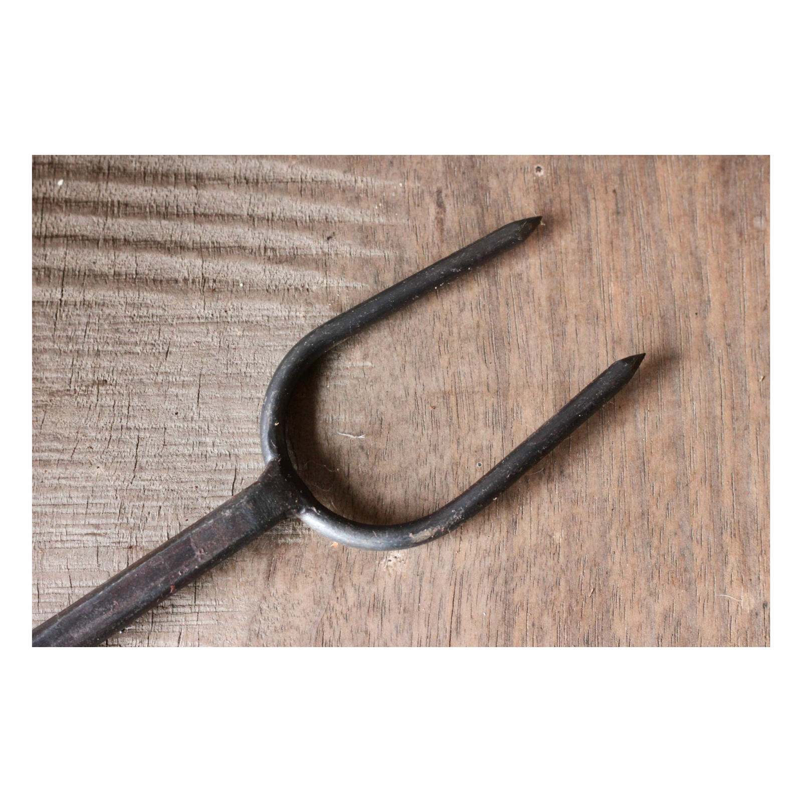 Vintage metal fork on a wooden surface