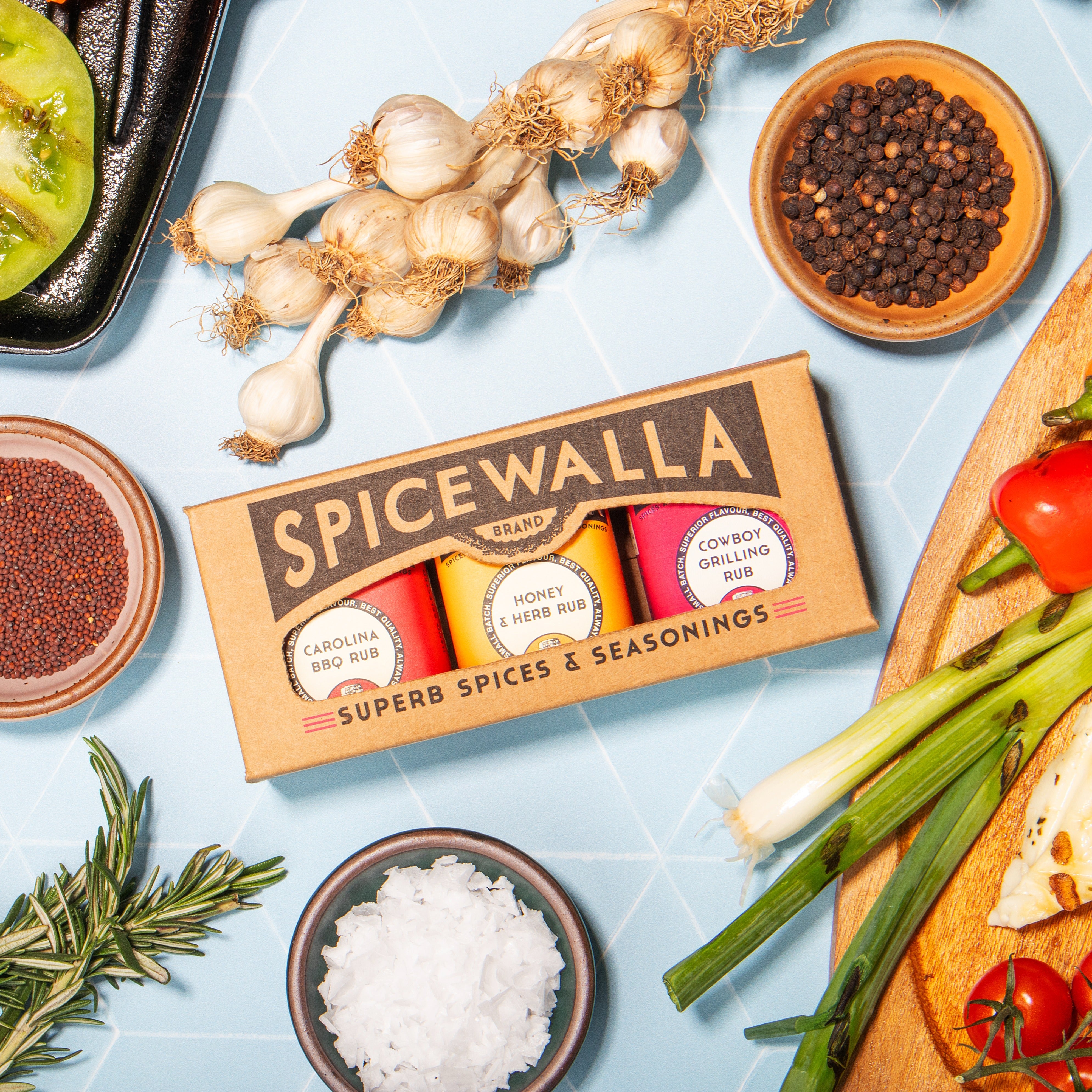 Spicewalla spice set with various spices and herbs on a light blue background