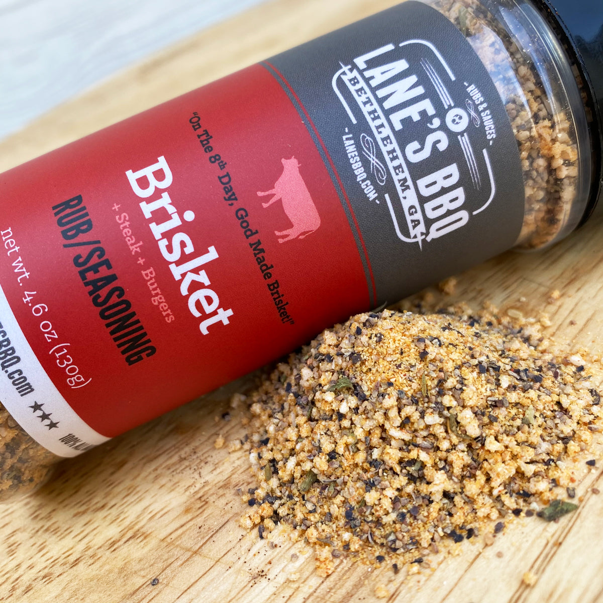 Lane's BBQ Brisket Rub/Seasoning container on a wooden surface
