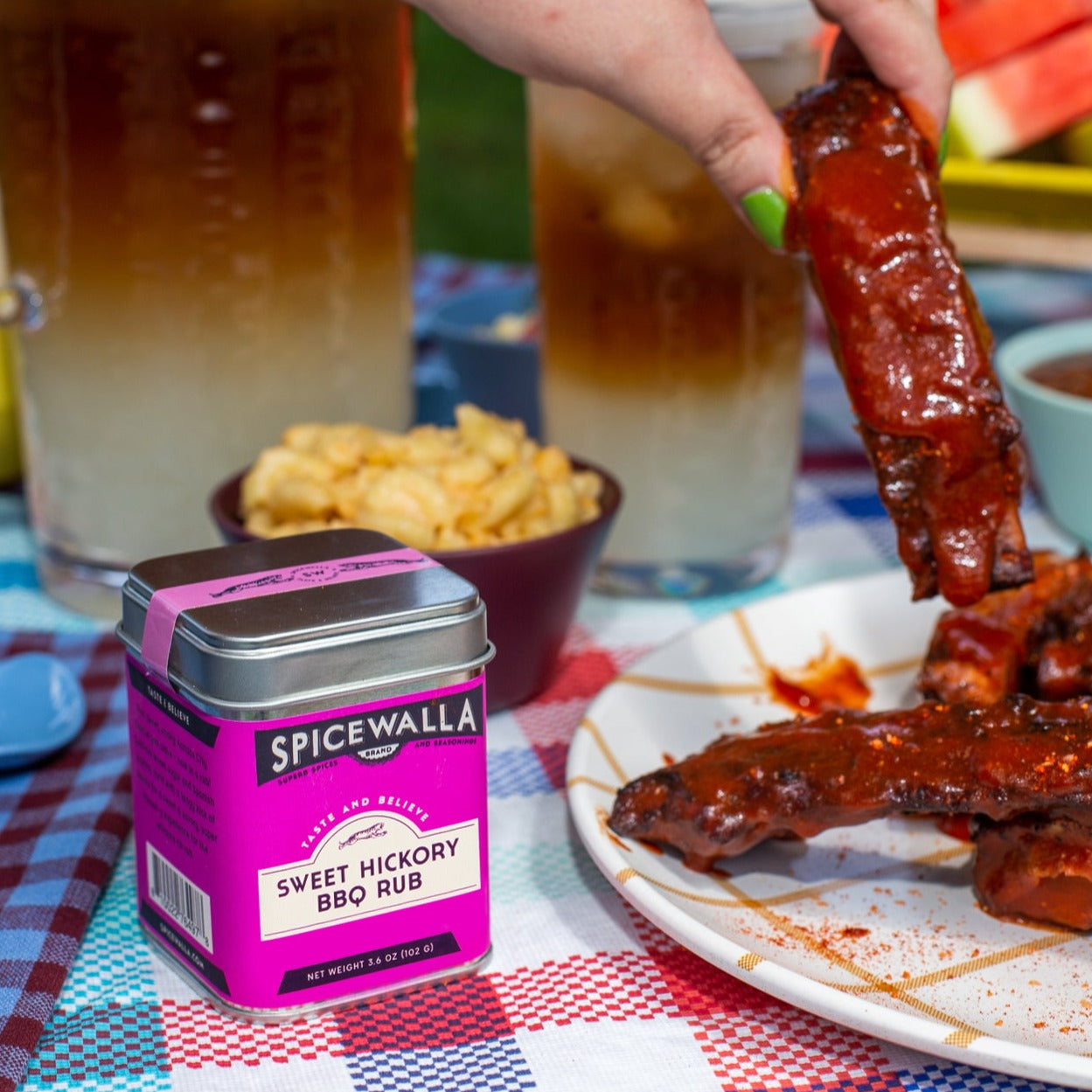 Spicewalla Sweet Hickory BBQ Rub with ribs and snacks on a table