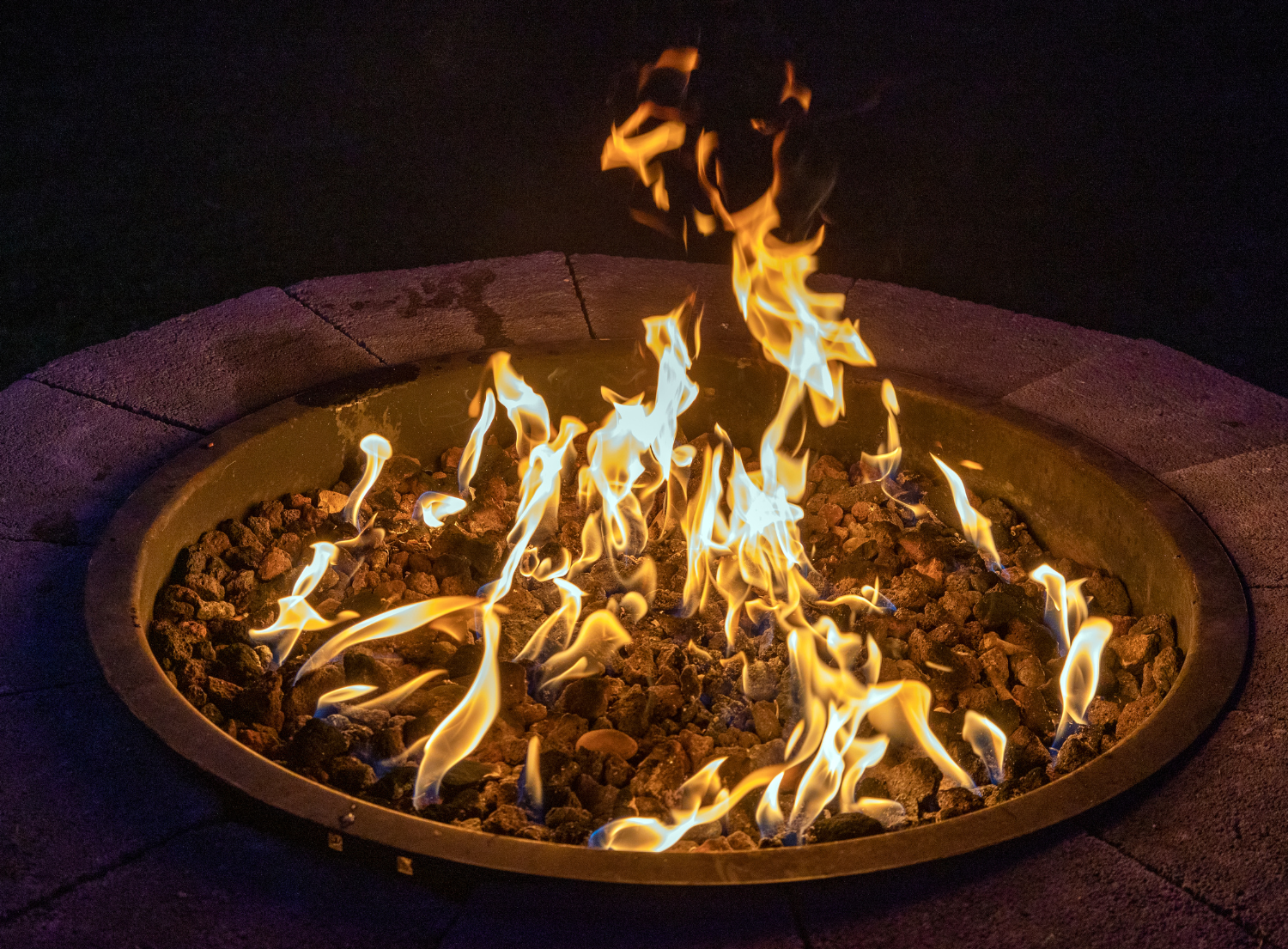 a large fire pit lit during night time