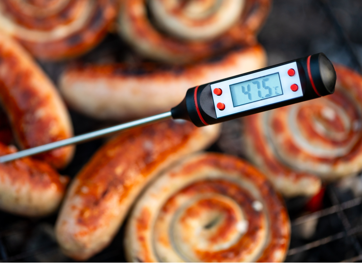 cooking thermometer testing temperature of sausages at 475 degrees