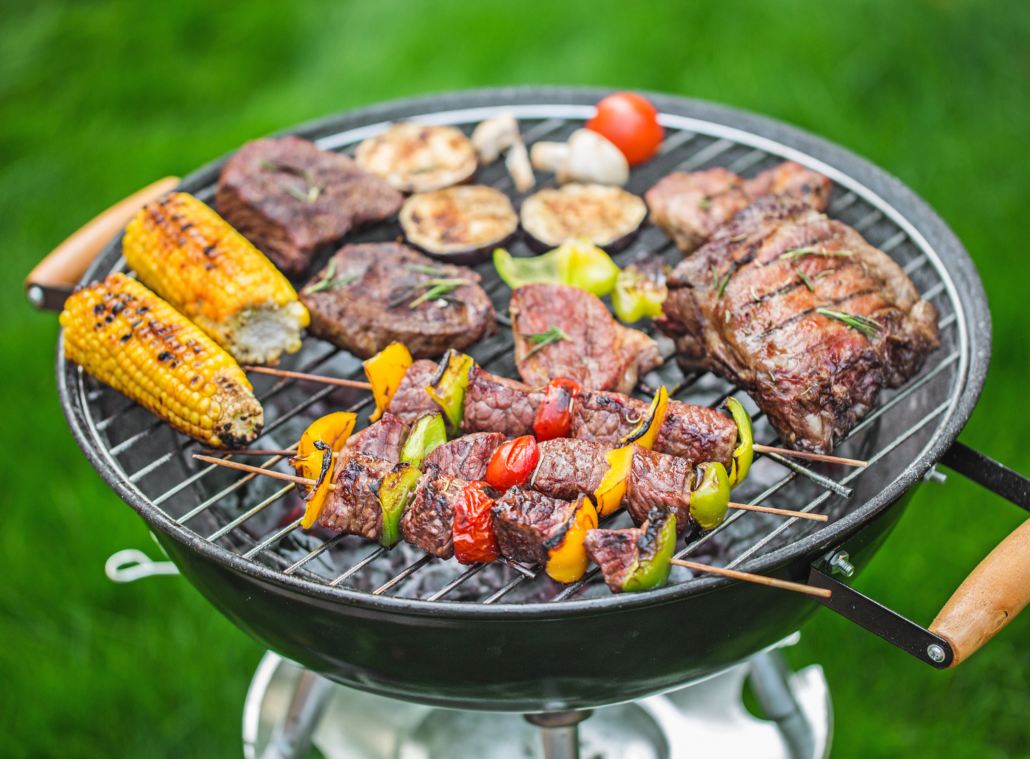 various meats and vegetables being grilled on the BBQ