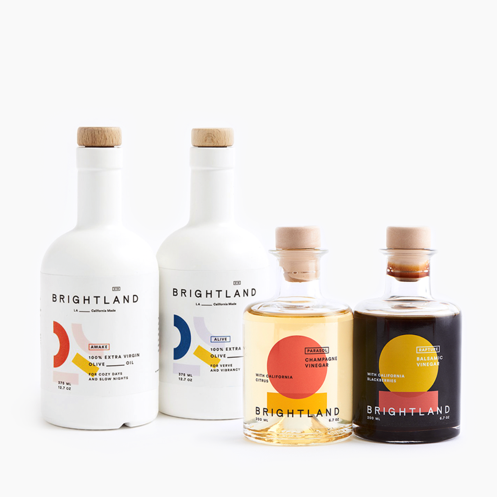 Four bottles of Brightland oils and vinegars on a white background