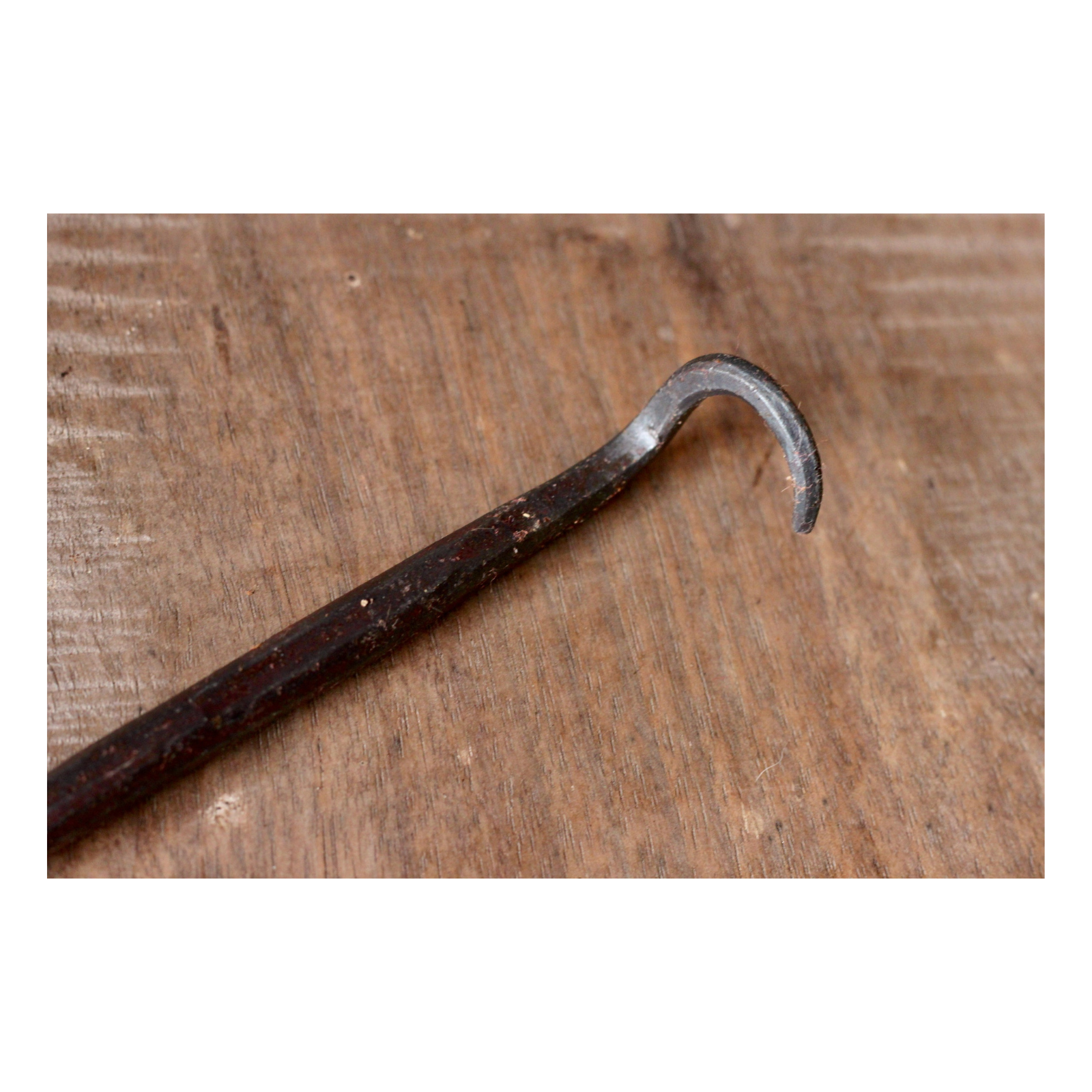 Metal hook on a wooden surface